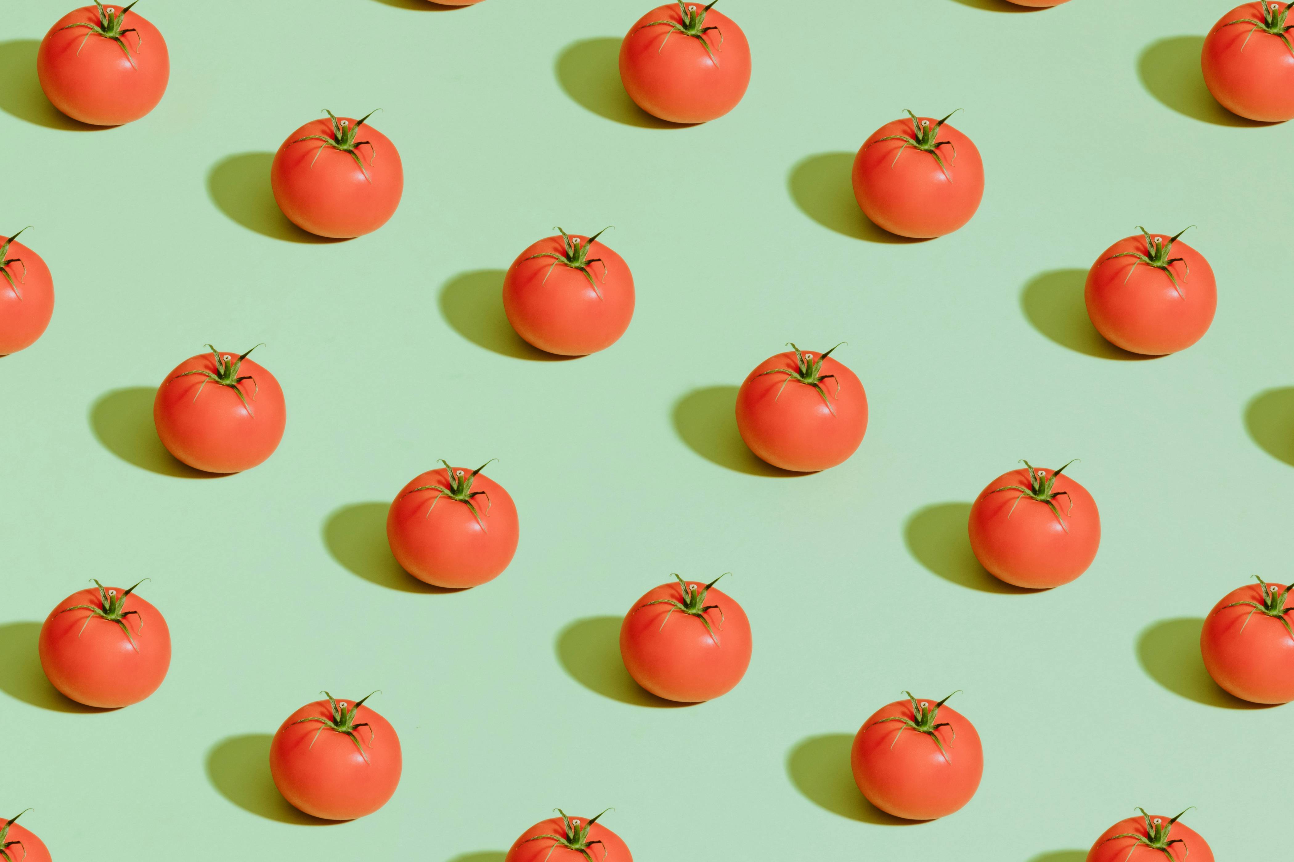red cherry fruits on pink surface
