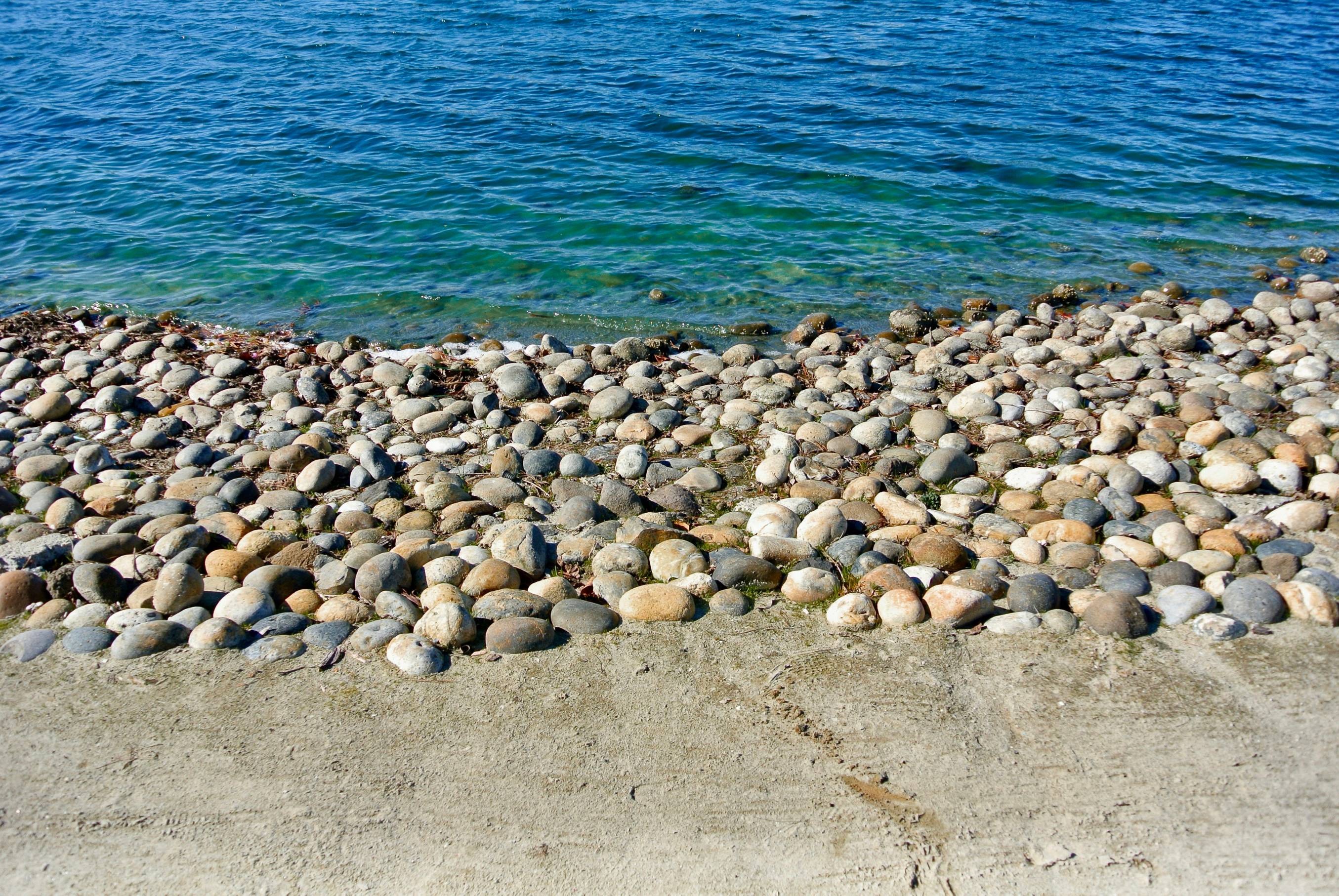 gray and white stones on seashore during daytime