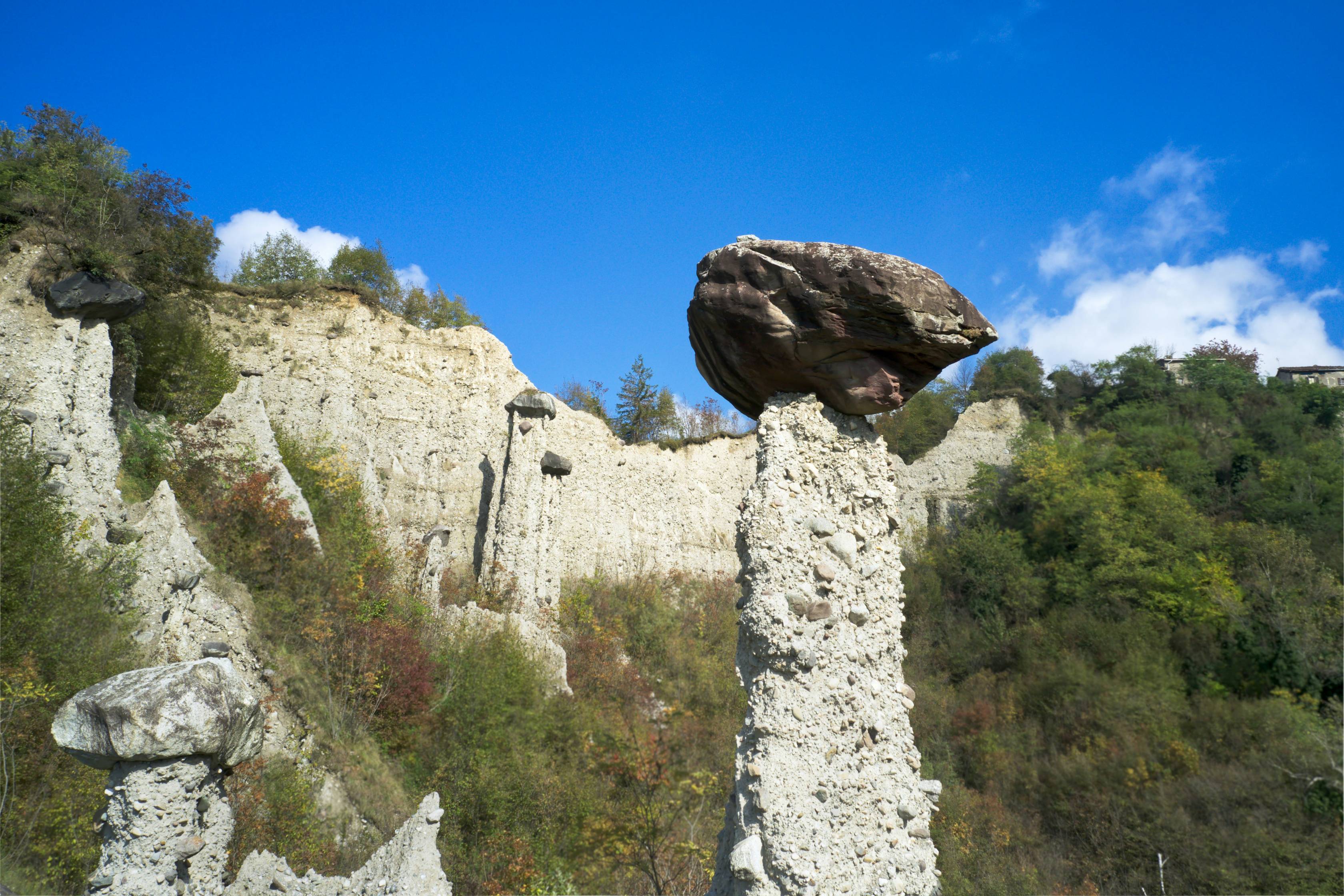 A rock formation in the middle of a field