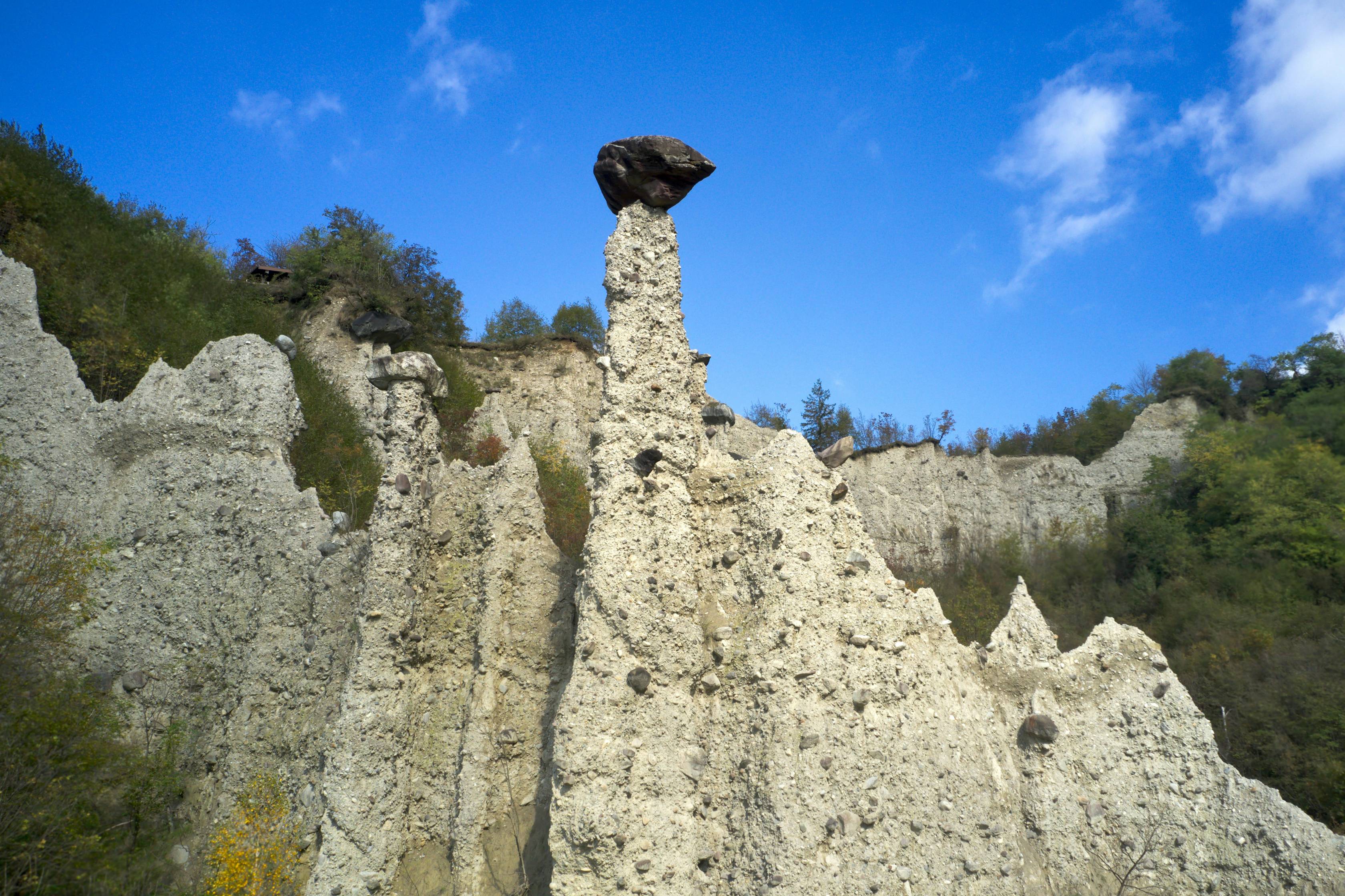 A rock formation with a bird perched on top of it