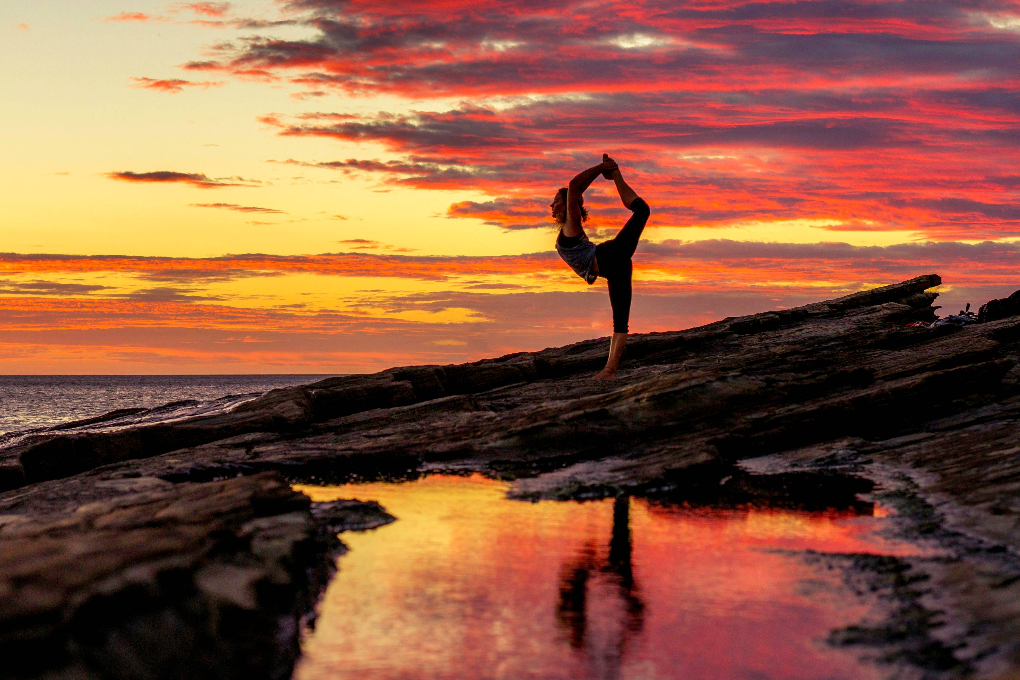 a person doing a handstand on a beach